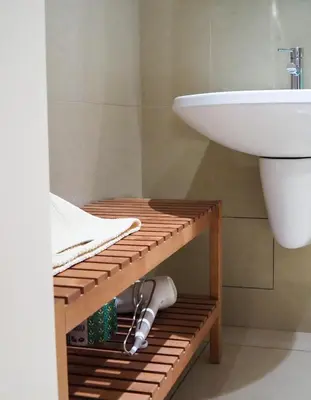 a bathroom with a white sink and a shelf with a sink at Žatecká - Old Town Residence in Prague