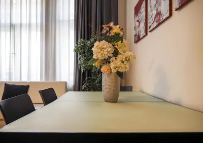 a vase filled with flowers sitting on a table at Žatecká - Old Town Residence in Prague