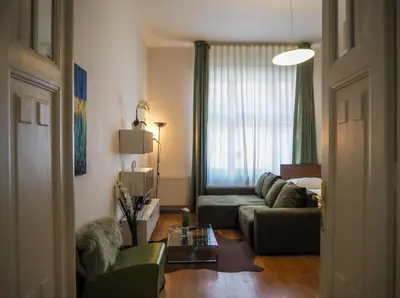 a living room with a couch and a table at Žatecká - Old Town Residence in Prague