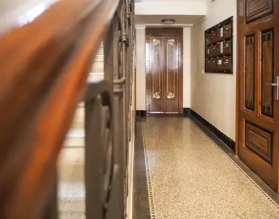 a hallway with a door and a stairwell at Žatecká - Old Town Residence in Prague