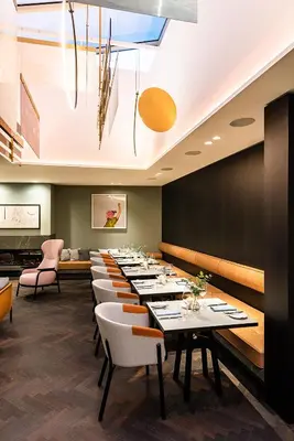 a long dining room with tables and chairs at Maximilian Hotel in Prague