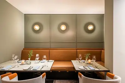 a dining room with two tables and chairs at Maximilian Hotel in Prague