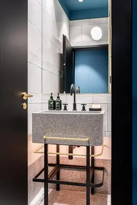 a bathroom with a sink with two bottles on it at Maximilian Hotel in Prague