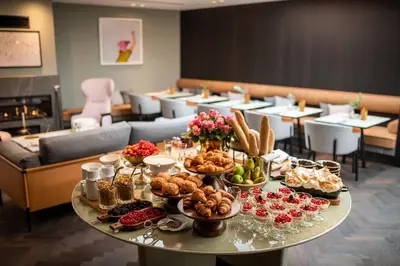 a table with food on it in a restaurant at Maximilian Hotel in Prague