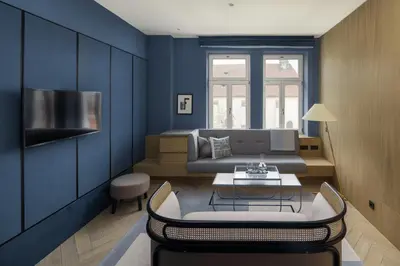 a blue living room with a couch and a table at Maximilian Hotel in Prague