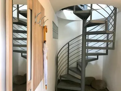a spiral staircase in a house with a door at Apartmán U babičky in Prague