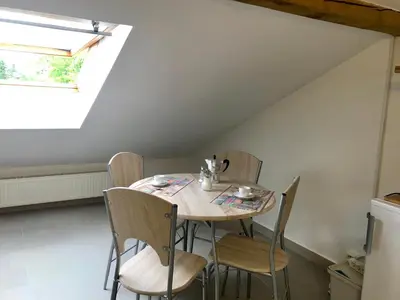 a table and chairs in a room with a window at Apartmán U babičky in Prague
