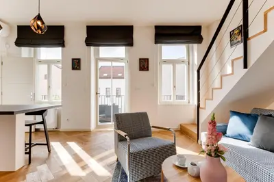 a living room with a couch and a table at Anděl design duplex, AC, garage in Prague