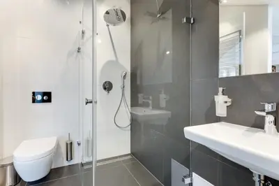 a bathroom with a shower and a toilet and a sink at Anděl design duplex, AC, garage in Prague