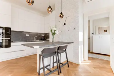a kitchen with a counter with a vase of flowers at Anděl design duplex, AC, garage in Prague