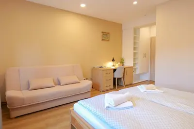 a bedroom with a bed and a couch and a desk at Penzion Harmony Javorník in Čtyřkoly