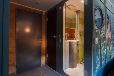 a bedroom with a large bed and a couch at Botel Marina in Prague