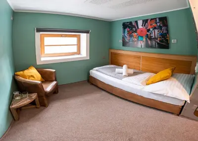 a small bed in a room with a window at Botel Marina in Prague
