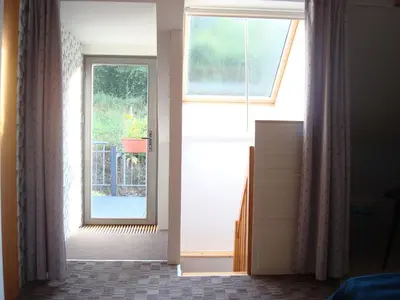 an open door with a window in a room at Apartmán pod Velkou Amerikou in Mořina