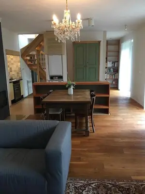 a living room with a table and a chandelier at Apartmán pod Velkou Amerikou in Mořina