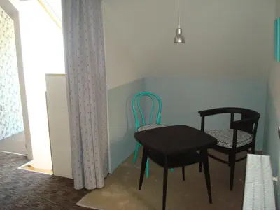 a dining room with two chairs and a table at Apartmán pod Velkou Amerikou in Mořina