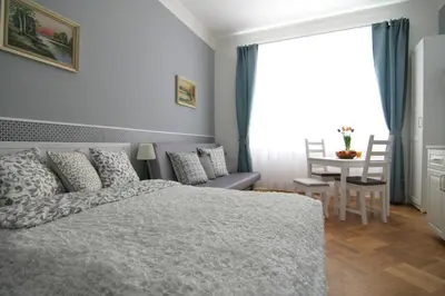 a bedroom with a bed and a table and chairs at ALLSTAR Vinohrady ateliers in Prague