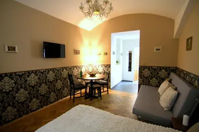 a living room with a table and a couch at ALLSTAR Vinohrady ateliers in Prague