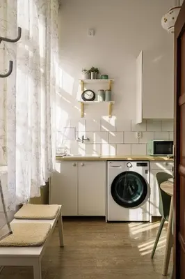 a kitchen with a washing machine in a kitchen at Wellness apartments Karlín in Prague