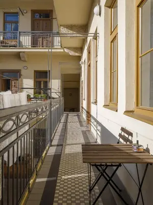 a balcony with a wooden bench on a building at Wellness apartments Karlín in Prague