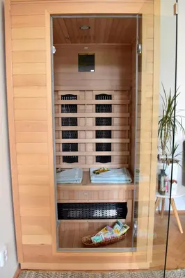 a wooden cabinet with some food inside of it at Wellness apartments Karlín in Prague