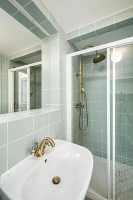 a bathroom with a sink and a shower at Downtown Designer apartment Karlin in Prague