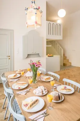 a dining room table with plates of food on it at Downtown Designer apartment Karlin in Prague