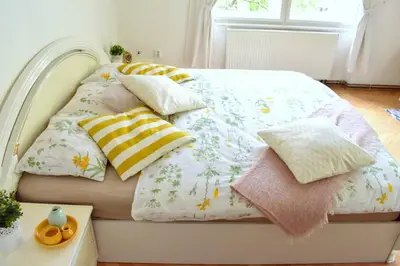 a bed with pillows on it in a bedroom at BEDROOM residence with SAUNA in Prague