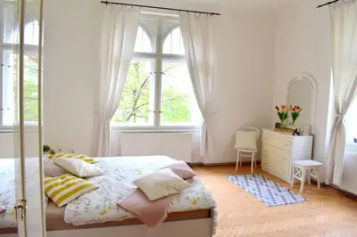 a bedroom with a bed and a dresser and a window at BEDROOM residence with SAUNA in Prague