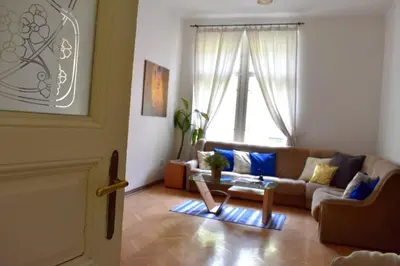 a living room with a couch and a table at BEDROOM residence with SAUNA in Prague