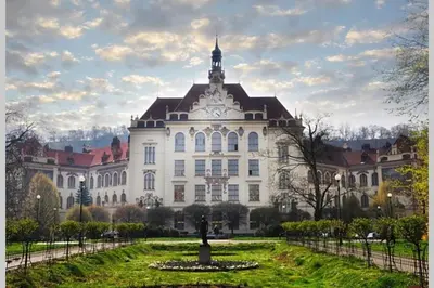 a large white building with a clock tower on it at BEDROOM residence with SAUNA in Prague