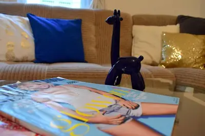 a magazine sitting on a coffee table in a living room at BEDROOM residence with SAUNA in Prague