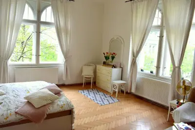 a bedroom with a bed and a dresser and windows at BEDROOM residence with SAUNA in Prague