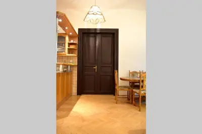 a door leading into a dining room with a table at BEDROOM residence with SAUNA in Prague