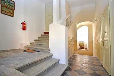 a staircase in a house with a red fire extinguisher at Romantic apartment under the Prague castle in Prague