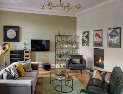 a living room with a couch and a fireplace at MN6 Luxury Suites by Adrez in Prague
