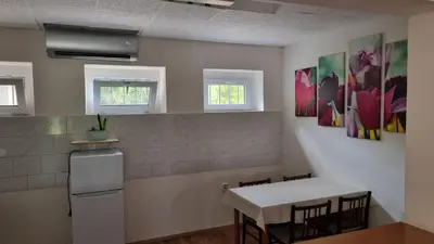 a kitchen with a table and a table and chairs at Apartmány Vinařství Klučov in Lstiboř