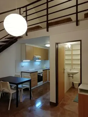 a kitchen with a table and a dining room at Apartmány Vinařství Klučov in Lstiboř