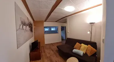 a living room with a couch and a table at Apartmány Vinařství Klučov in Lstiboř