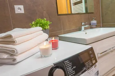 a bathroom with a microwave and a candle on a counter at Apartment Oscar with garage in Prague