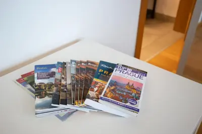 a pile of magazines sitting on a table at Apartment Oscar with garage in Prague