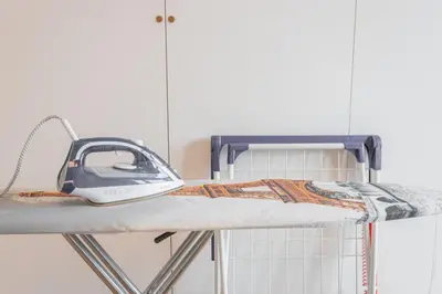 a iron sitting on top of a bunk bed at Apartment Oscar with garage in Prague