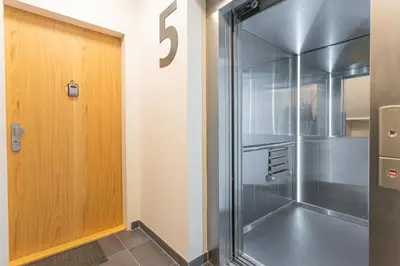 a shower with a glass door in a room at Apartment Oscar with garage in Prague