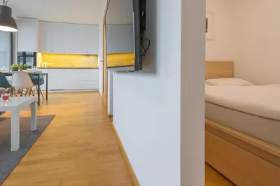 a small apartment with a bed and a dining room at Apartment Oscar with garage in Prague