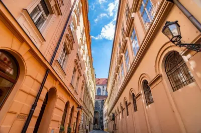 an alley between two buildings in a city at APTs in OLD TOWN PRAGUE by Michal&Friends in Prague