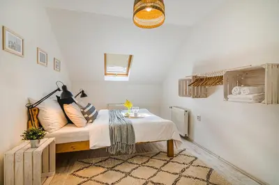a bedroom with a bed with a table in it at APTs in OLD TOWN PRAGUE by Michal&Friends in Prague