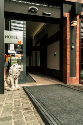 a lion statue sitting in front of a hotel at Hotel JURKOS in Příbram