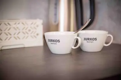 two coffee cups sitting on a table at Hotel JURKOS in Příbram