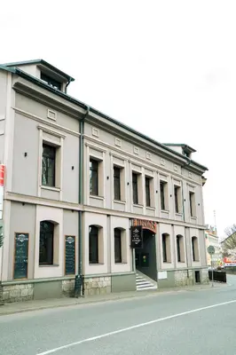 a large white building on the side of a street at Hotel JURKOS in Příbram