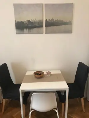 a white table with two chairs and a bowl on it at Apartmen -Studio in Prague